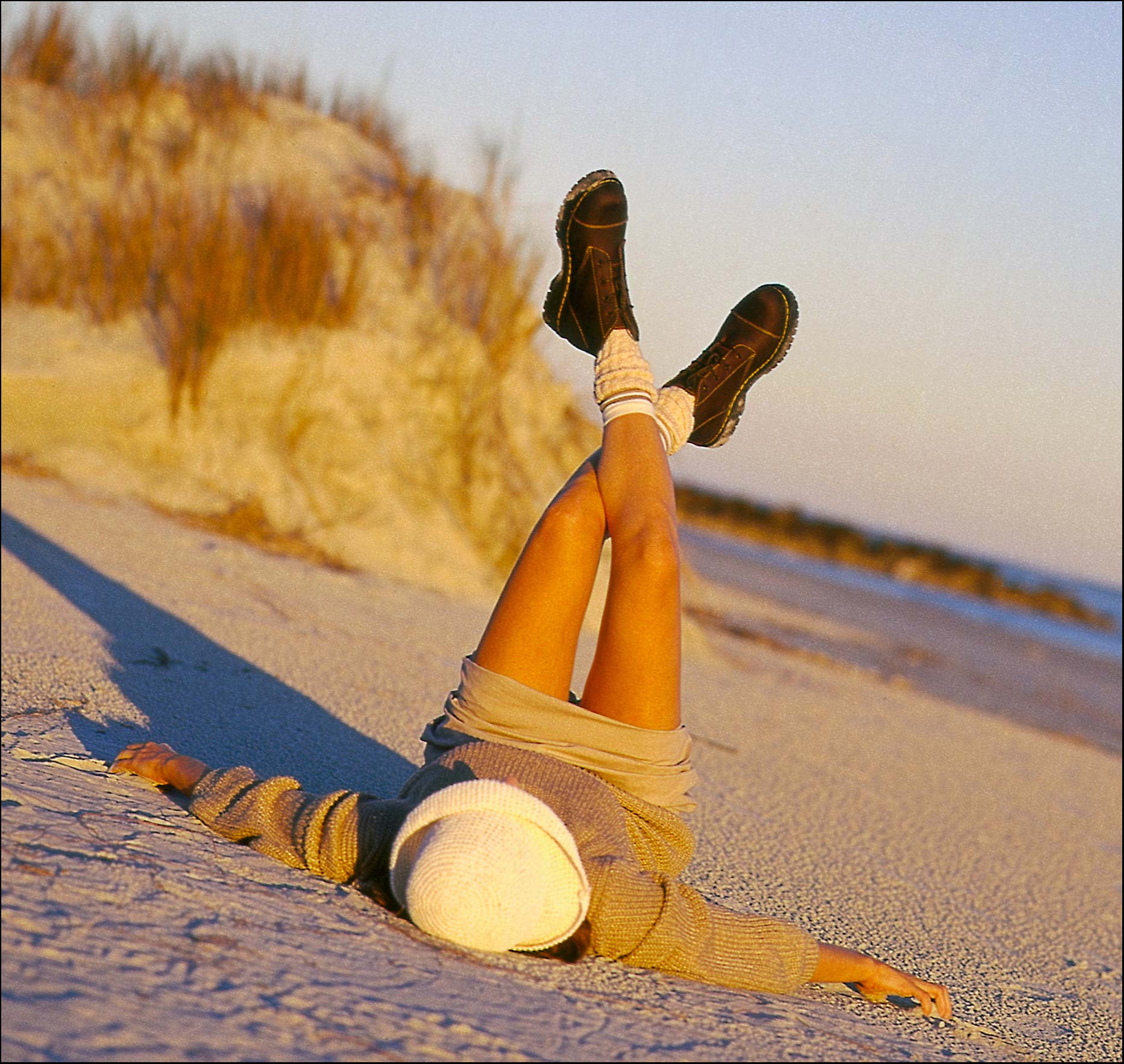 Girl lying on a beach wearing socks